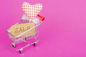 Seasonal sales. Shopping cart shopping cart on bright background photo