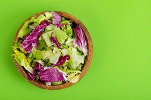 Light dietary vegetarian salad in plate on bright background. Healthy lifestyle concept photo