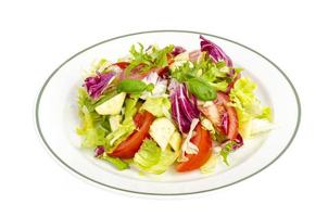 Plate with lettuce, tomatoes, olive oil. Vegetarian menu. photo