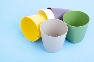 Bright blank flower pots on color paper background. photo