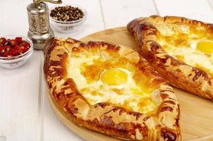 Homemade cakes, khachapuri with cheese and egg photo