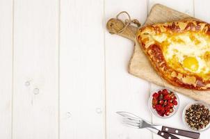 Homemade cakes, khachapuri with cheese and egg photo