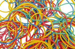 Many colourful multi coloured elastic rubber bands on white background. photo