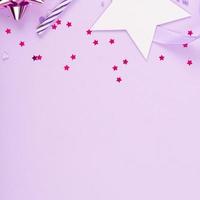 Party Holiday Background with ribbon, stars, birthday candles and confetti on pink background. Studio Photo