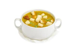 Vegetable cream soup with wheat croutons in bowl isolated on white background