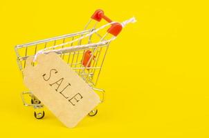 Seasonal sales. Shopping cart shopping cart on bright background photo