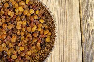 Dried grapes, raisins in wooden bowl. Studio Photo