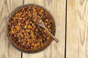 Dried grapes, raisins in wooden bowl. Studio Photo