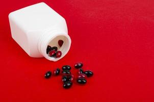 Bicolor medical pills on bright background. Photo