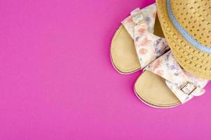 Summer composition of hats and shoes on bright background photo