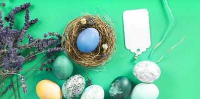 Colorful background with Easter eggs on green background. Happy Easter concept. Can be used as poster, background, holiday card. Flat lay, top view, copy space. Studio Photo