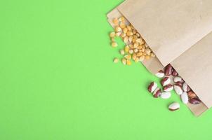 Vegetable seeds in kraft paper bags on bright background photo