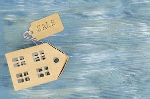 Real estate sale concept, paper model of residential building. photo