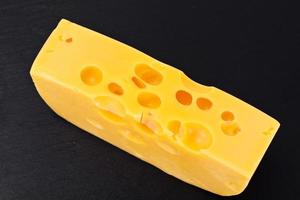 Swiss Cheese on Black Background photo