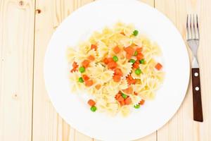 Pasta Bow with Diced Carrots, Salami and Green Peas photo