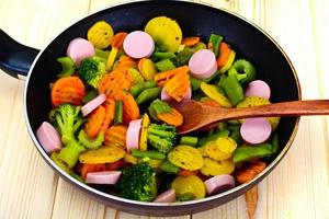 Steamed Vegetables Potatoes, Carrots and Broccoli with Sausages photo