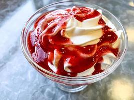 Dessert with whipped cream, strawberry sauce. photo. photo