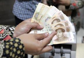 Hands holding some 20 yuan bills photo