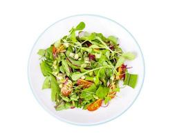 Salad of young leaves of beet, cherry, radish and pumpkin seeds. photo