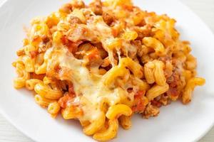 homemade macaroni bolognese with cheese photo