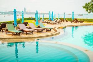 chair pool or bed pool and umbrella around swimming pool photo