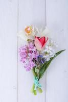 Bouquet of spring garden flowers on white background. photo