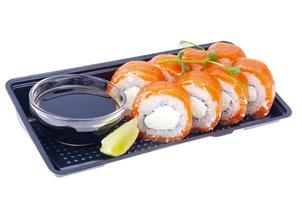 Black plate with rolls with salmon and soy sauce, Japanese cuisine photo