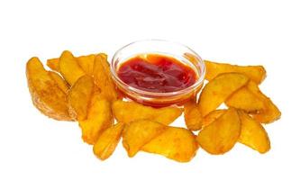 Rustic potato wedges and ketchup on white background photo