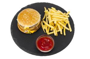 Hamburger and french fries, ketup on black plate. photo