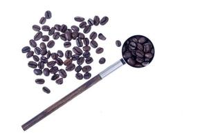 Coffee beans and vintage spoon on white background. Studio Photo