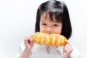 Child eats long bread. Snack during the day.