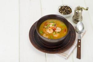 Spicy thai shrimp soup on plate. Studio Photo. photo