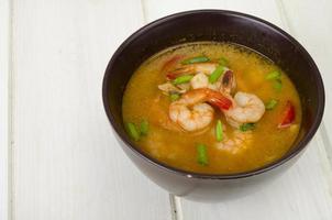 Spicy thai shrimp soup on plate. Studio Photo. photo