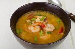 Spicy thai shrimp soup on plate. Studio Photo. photo