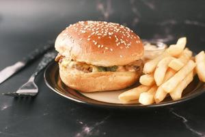 junk foods on plate on wooden table close up photo