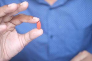 Close up of man hand holding pills with copy space photo