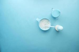 Close up of baby food in a bowl on blue background photo