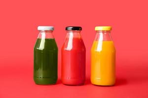 Different healthy juice on color background photo