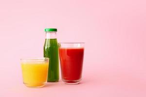 Different healthy juice on color background photo