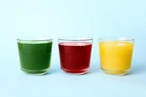 Different healthy juice on color background photo