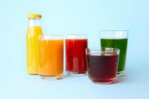 Different healthy juice on color background photo