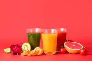 Different healthy juice on color background