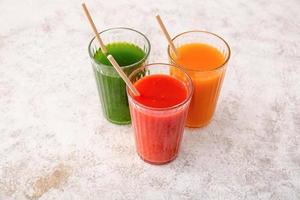 Glasses with healthy juice on light background