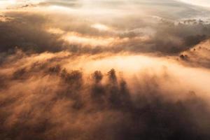 Flying above the clouds sunrise and fog photo