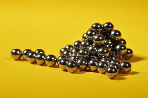 steelballs stacked with yellow background photo