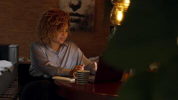 Woman sitting at table having video call