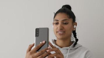 Woman having video call with smartphone