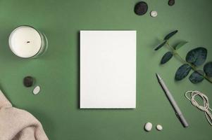 Blank white sheet of paper with an envelope green background photo