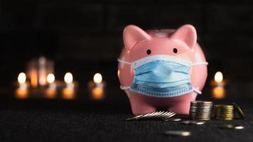 Piggy bank in a medical mask with coins photo