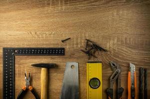 Hand tools lie on a wooden table photo
